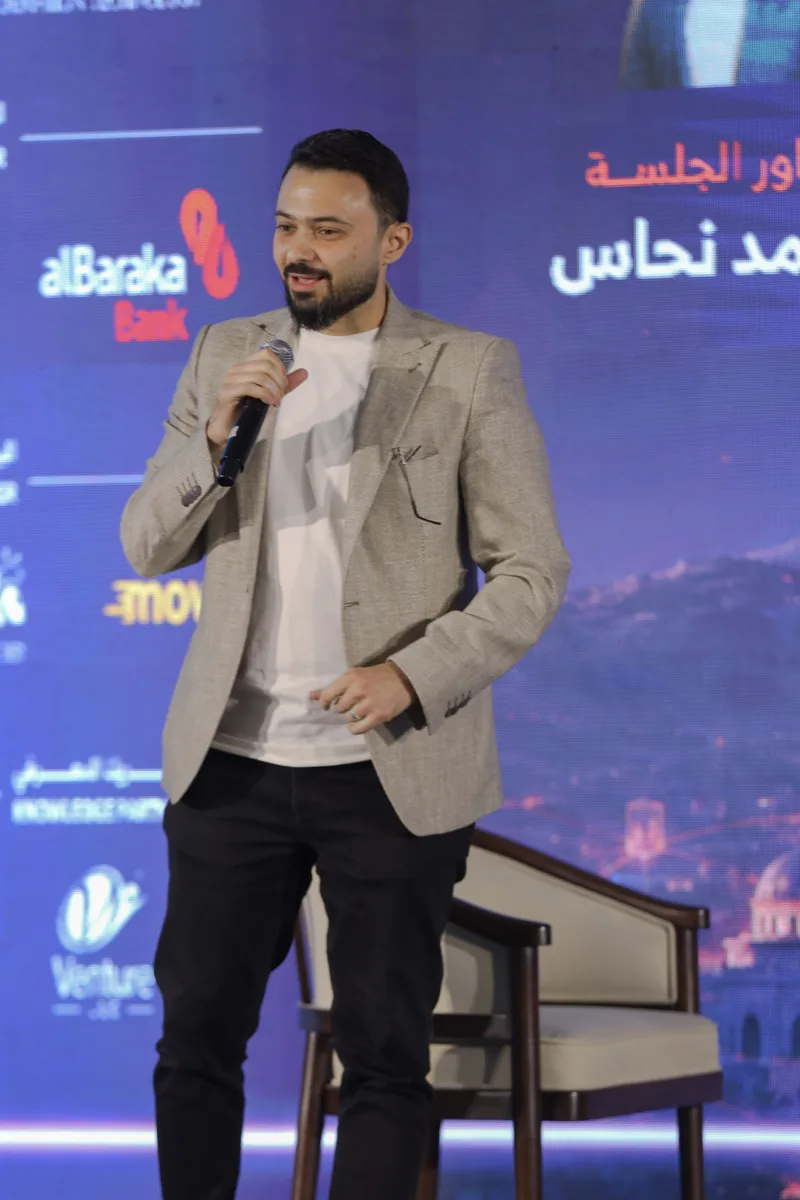 Ahmad Nahas speaking on stage